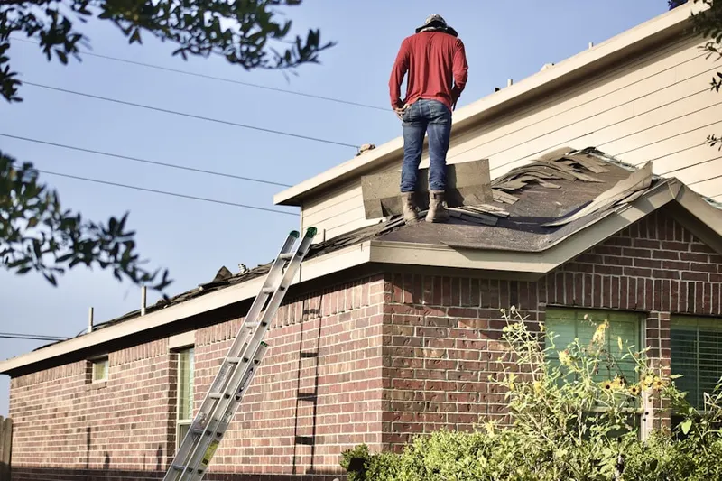 Professional roofer working on a residential roof in Lakehurst